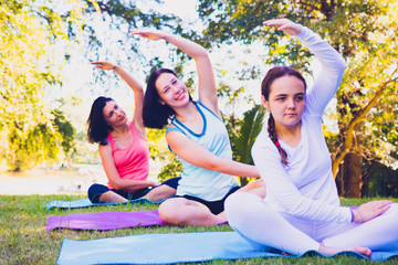 Group people have meditation for yoga.In the morning they are sitting on mat and play yoga in...