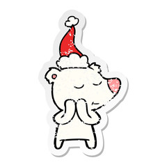 happy distressed sticker cartoon of a polar bear wearing santa hat