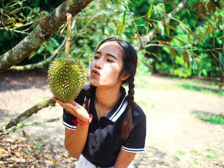 Durian lover woman kissing durian in the field