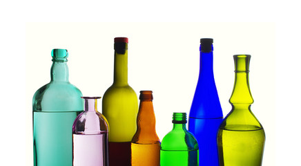 Two glasses of wine and bottles of wine and gin on the light.