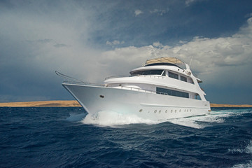 Luxury motor yacht sailing out on tropcial sea
