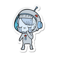 Obraz premium sticker of a cartoon crying astronaut girl