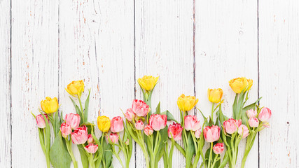 Red tulips bouquet on white wooden background