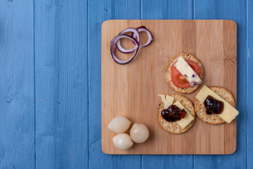 Top view of a cheese board with crackers 