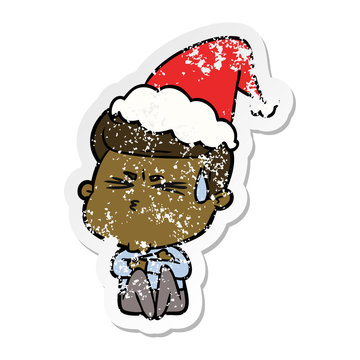 distressed sticker cartoon of a man sweating wearing santa hat