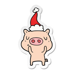 sticker cartoon of a content pig wearing santa hat