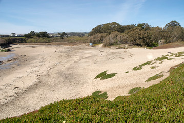 sandy beach with lifeguard tower in the background
