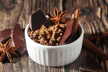 Obraz na płótnie Canvas Cocoa powder and a bar of dark chocolate