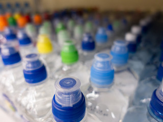 Lid plastic water bottle in the market. multi-colored plastic bottle caps	