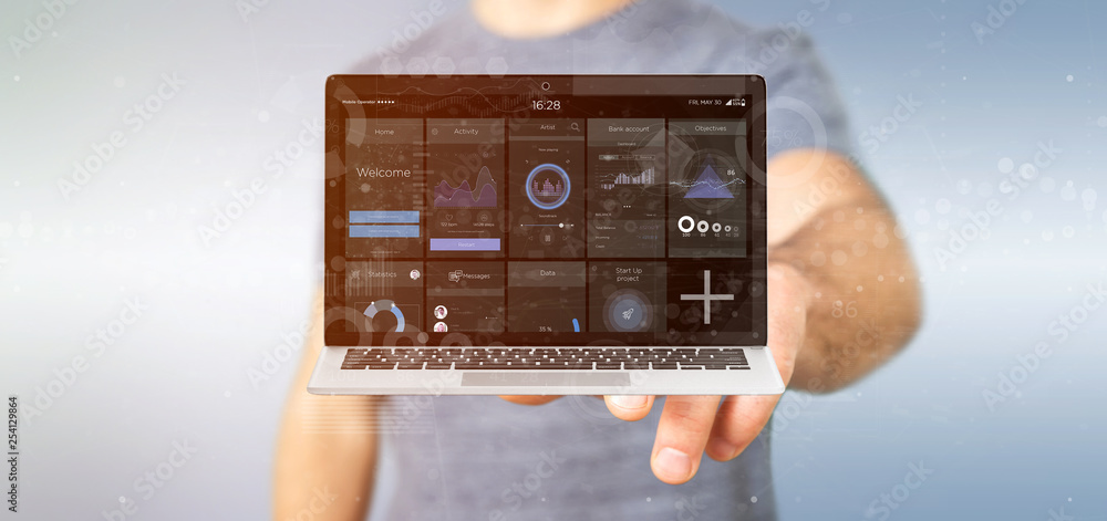 Poster businessman holding laptop with business user interface data on the screen isolated on a background