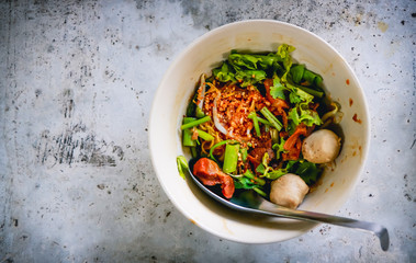 Asian noodles with vegetables on the cement table. Top view with copy area.
