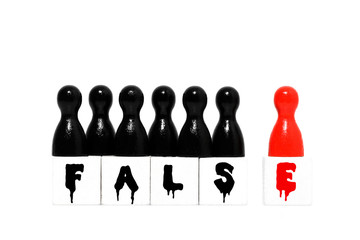 False symbol with game pieces