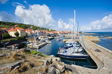 View of fishing boats and yachts moored in the harbor in Gudhjem, Bornholm island, Denmark