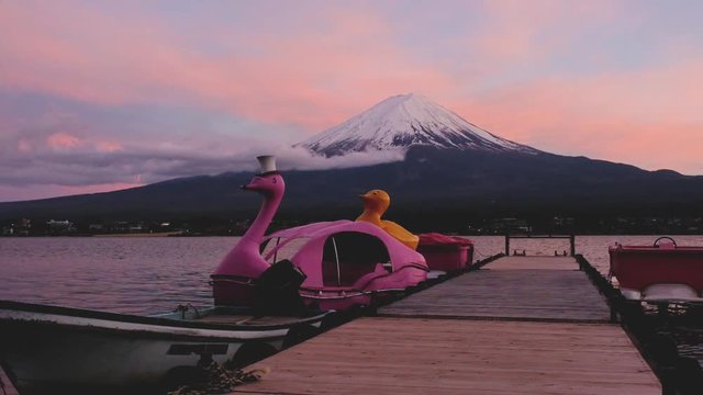 Mount fuji san at Lake kawaguchiko in japan on sunrise with the animal boat in the bay shore.