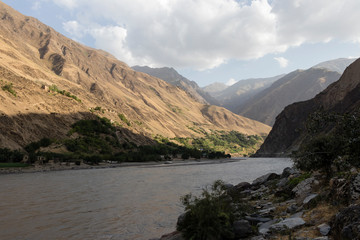Desert-like landscape of Afghanistan with a river in the Pamir Mountains