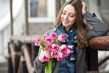 Fototapeta premium Woman with tulips. Beautiful woman with flowers.