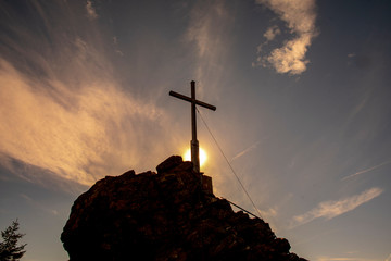 Summit cross with sun at Silberberg in Bodenmais in the Bavarian Forest