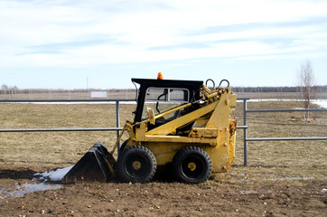 Mini yellow tractor for snow removal. Farm.