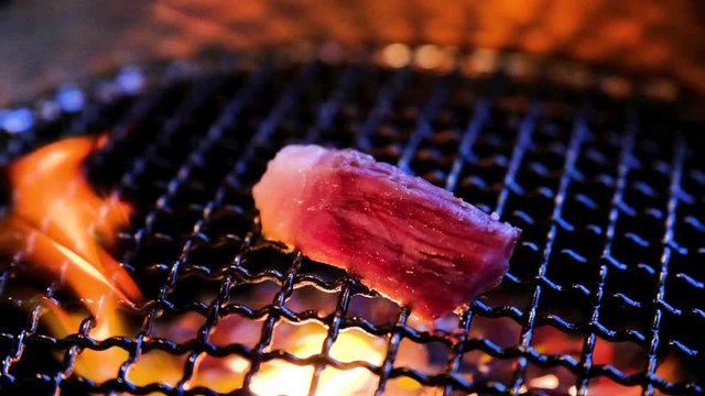 SLOW MOTION FOOD: Beef BBQ on grill in slow motion