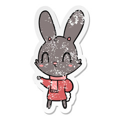 distressed sticker of a cute cartoon rabbit wearing clothes