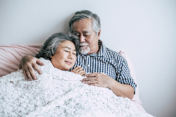 Senior couple lying in bed together