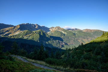 Naklejka na ściany i meble Tatra mountain peaks with tourist hiking trails in sunny summer day