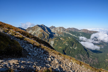 Tatra mountain peaks with tourist hiking trails in sunny summer day