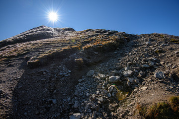 Tatra mountain peaks with tourist hiking trails in sunny summer day