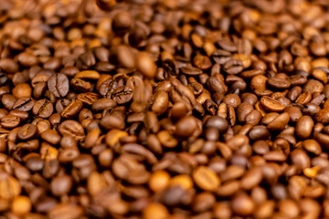 Coffee beans bright saturated texture. Roasted coffee beans background.