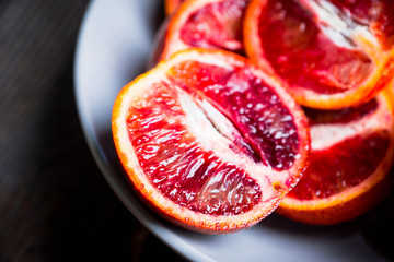 Sweet juicy red oranges on the rustic background. Selective focus. Shallow depth of field. 