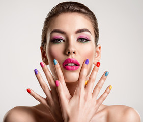 Beautiful fashion woman with a colored nails. Attractive white girl with multicolor manicure.