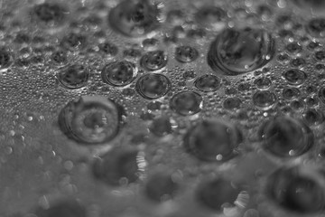 Closeup water condensation on window glass background. Waterdrops, dew drops. Selected focus, bokeh background, sparkles and shining. Macrophotography.