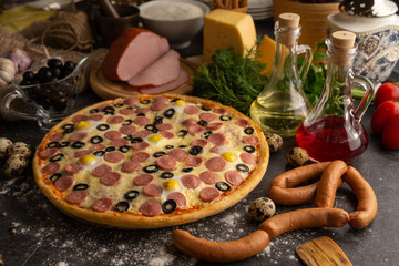Pizza with sausages, boiled pork and quail eggs.