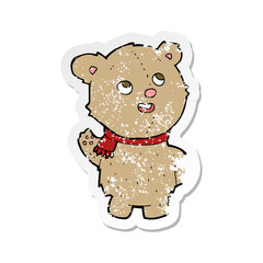 retro distressed sticker of a cartoon cute teddy bear with scarf