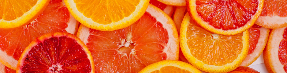 Different kinds of oranges and grapefruit slices background