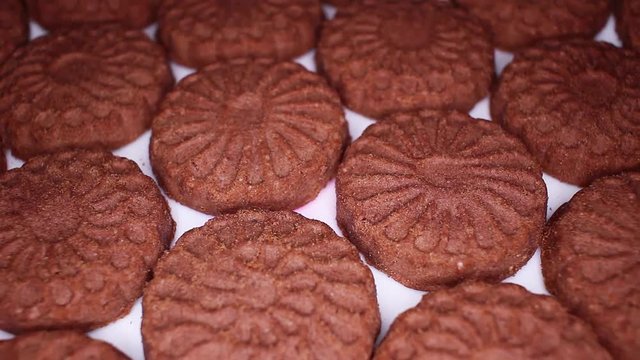 Chocolate biscuit closeup texture video on rolling rotating looping plate