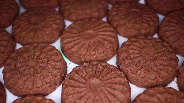 Chocolate biscuit closeup texture video on rolling rotating looping plate