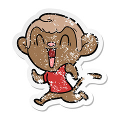 distressed sticker of a cartoon laughing monkey