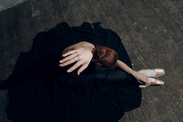 Ballerina female. Young beautiful woman ballet dancer, dressed in professional outfit, pointe shoes and black tutu.