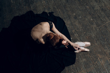 Ballerina female. Young beautiful woman ballet dancer, dressed in professional outfit, pointe shoes and black tutu.