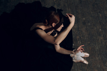 Ballerina female. Young beautiful woman ballet dancer, dressed in professional outfit, pointe shoes and black tutu.