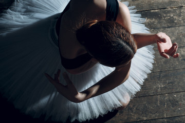 Ballerina female. Young beautiful woman ballet dancer, dressed in professional outfit, pointe shoes and white tutu.