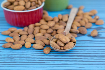 Almond nut on wood spoon.