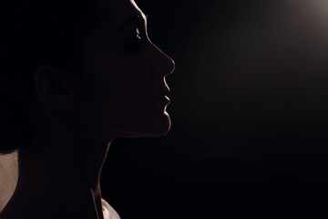 Edge lit profile woman portrait.