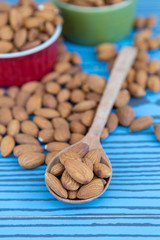 Almond nut on wood spoon.