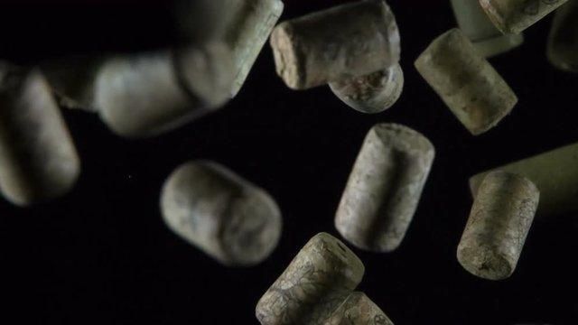 Soaring Wine Corks in Three Versions. Set of three videos. Wine corks in large quantity in the air slowly stuck on a black background. Filmed at a speed of 240fps