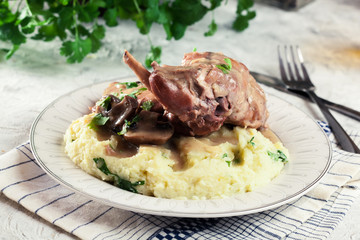 Stewed rabbit legs with vegetables