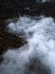 Aerial view of fog, clouds over the trees and mountains of the Caucasus, Sochi area, Krasnaya Polyana, Gorki Gorod.