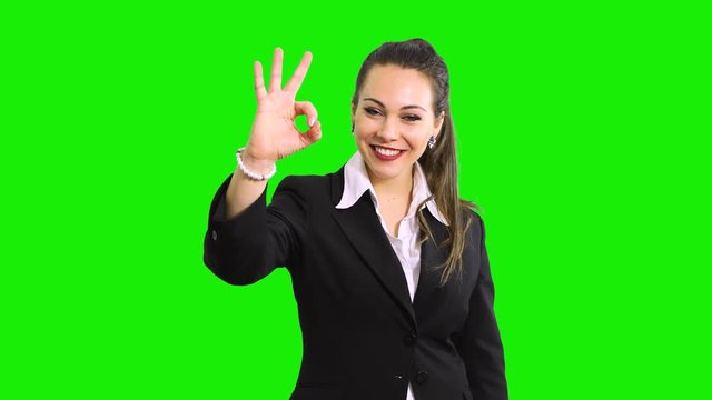 Young business woman indicating ok sign. Isolated over green screen chroma key background