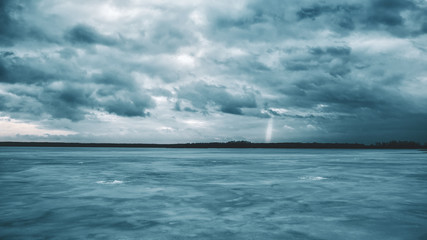 A ray of sunshine over a frozen lake.